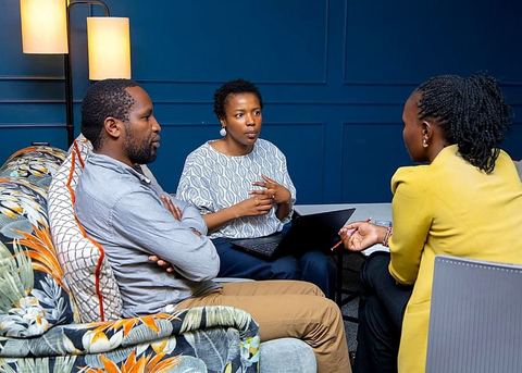 Three participants in discussion during a workshop on digital agribusiness learning
