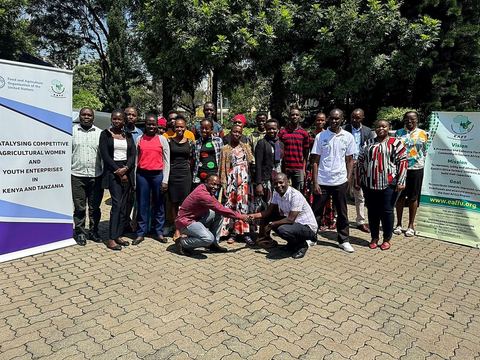 Women and youth entrepreneurs from Kenya and Tanzania standing together during an exchange visit
