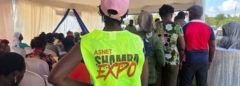 Farmers attending a training session under a tent at the ASNET Shamba Expo